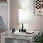 Lamp on a nightstand with a smartphone and smartwatch, in a room setting.