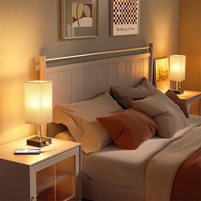 Cozy bedroom with a bed, nightstands, and modern rectangular bedside lamps creating a warm atmosphere, while charging phone.